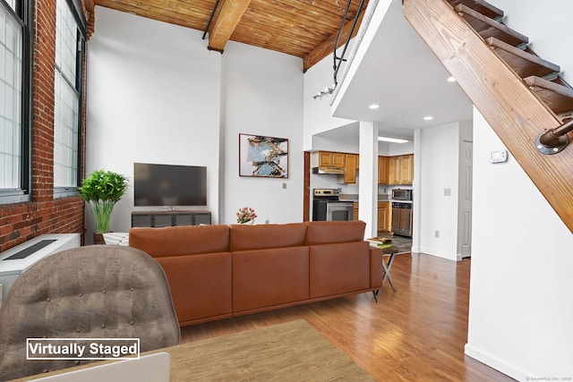 25 Grand St Apt 102, Norwalk, CT 06851 - living area with light wood finished floors, wooden ceiling with exposed beams, recessed lighting, and a high ceiling