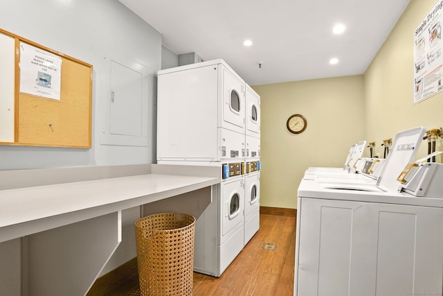 25 Grand St Apt 102, Norwalk, CT 06851 - community laundry room featuring washing machine and clothes dryer, stacked washer / drying machine, light wood-style floors, and recessed lighting