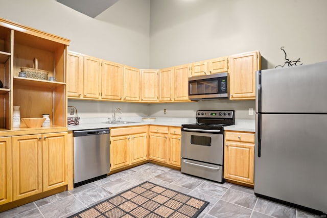 25 Grand St Apt 102, Norwalk, CT 06851 - kitchen featuring appliances with stainless steel finishes, light brown cabinetry, a sink, light countertops, and a towering ceiling