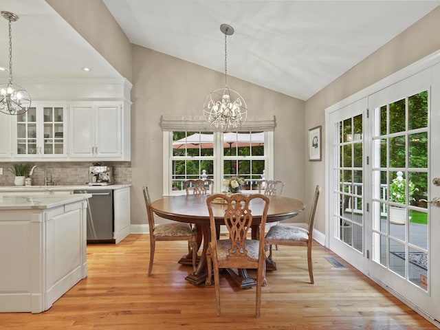 28 Eagle Dr, Fairfield, CT 06825 - dining space with a chandelier, vaulted ceiling, light wood-style floors, and baseboards