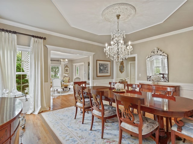 28 Eagle Dr, Fairfield, CT 06825 - dining room featuring a chandelier, a tray ceiling, light wood finished floors, a wainscoted wall, and a decorative wall