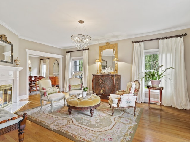 28 Eagle Dr, Fairfield, CT 06825 - living area featuring wood finished floors, a premium fireplace, ornamental molding, and a chandelier