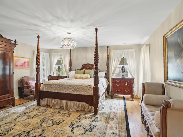 28 Eagle Dr, Fairfield, CT 06825 - bedroom with light wood-style flooring and a chandelier