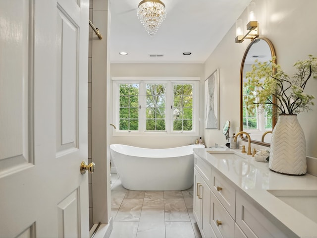 28 Eagle Dr, Fairfield, CT 06825 - full bath with marble finish flooring, a freestanding bath, plenty of natural light, double vanity, and recessed lighting