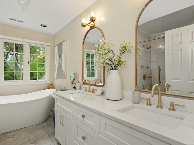 28 Eagle Dr, Fairfield, CT 06825 - full bath featuring a freestanding tub, double vanity, a shower stall, and healthy amount of natural light