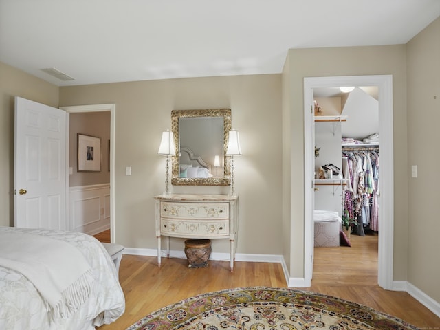 28 Eagle Dr, Fairfield, CT 06825 - bedroom featuring wood finished floors, a walk in closet, a closet, and baseboards