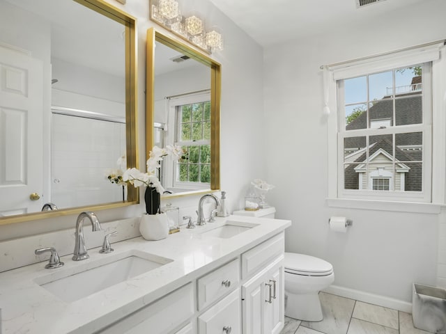 28 Eagle Dr, Fairfield, CT 06825 - bathroom featuring double vanity, toilet, a shower with door, and baseboards