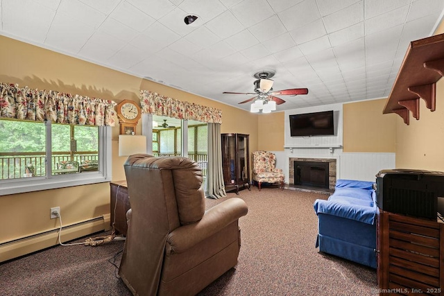154 Sims Rd, Bristol, CT 06010 - living room with a baseboard heating unit, a fireplace with raised hearth, carpet, ceiling fan, and wainscoting