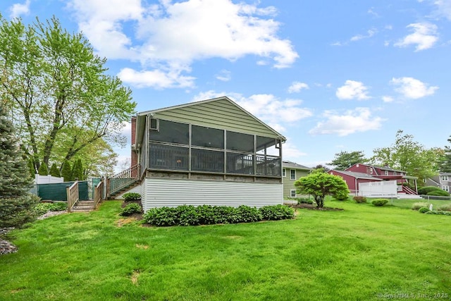 154 Sims Rd, Bristol, CT 06010 - rear view of house with a sunroom, stairs, and a lawn