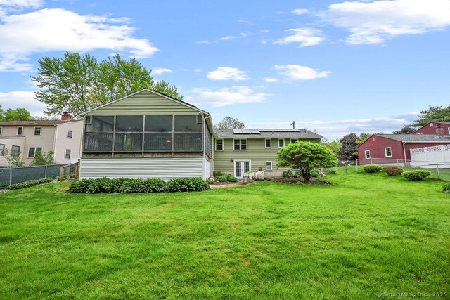 154 Sims Rd, Bristol, CT 06010 - back of house featuring roof mounted solar panels and a sunroom