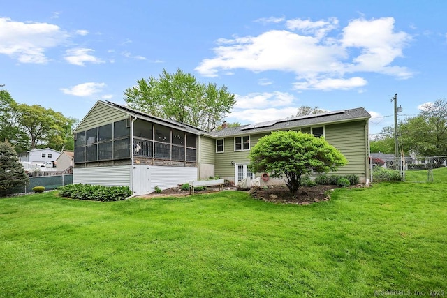 154 Sims Rd, Bristol, CT 06010 - rear view of house with a sunroom and roof mounted solar panels