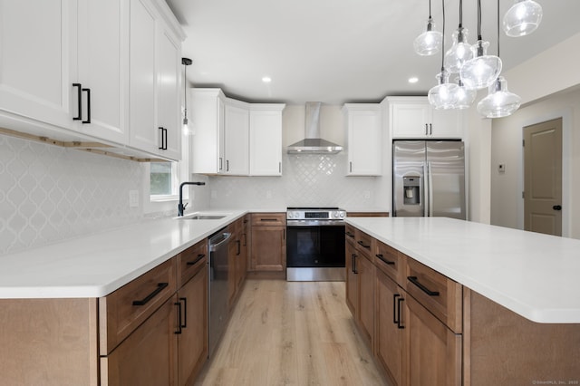 132 Bailey Pond Rd, Voluntown, CT 06384 - kitchen featuring stainless steel appliances, wall chimney range hood, a sink, light wood-style floors, and white cabinetry