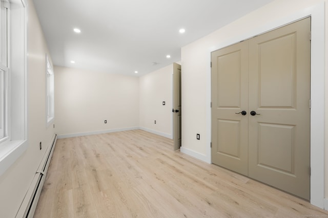 132 Bailey Pond Rd, Voluntown, CT 06384 - basement featuring baseboard heating, light wood-type flooring, recessed lighting, and baseboards