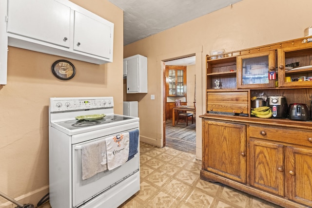 245 Ledyard St, New London, CT 06320 - kitchen featuring white electric stove, white cabinetry, open shelves, light flooring, and brown cabinetry