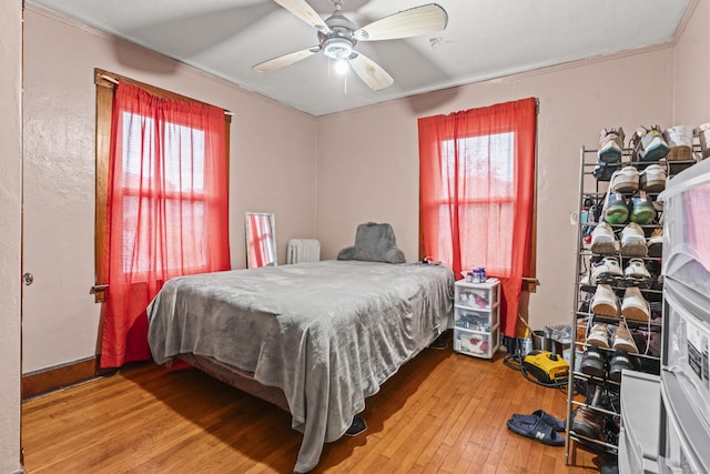 245 Ledyard St, New London, CT 06320 - bedroom featuring wood-type flooring, multiple windows, ornamental molding, a ceiling fan, and radiator