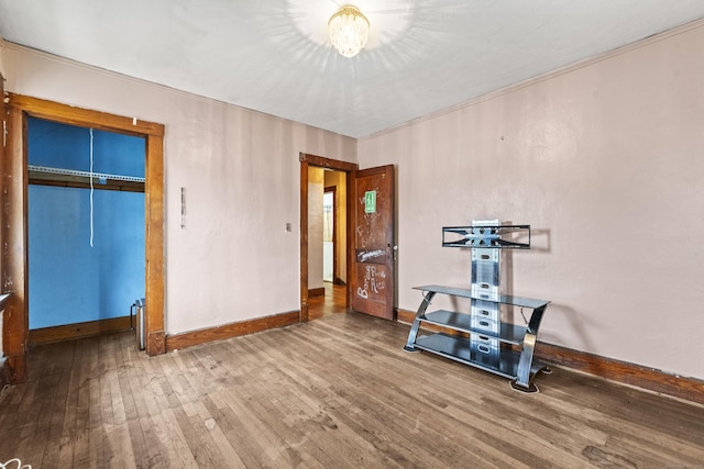 245 Ledyard St, New London, CT 06320 - empty room with wood finished floors, baseboards, and ornamental molding