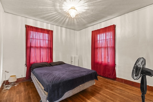 245 Ledyard St, New London, CT 06320 - bedroom featuring radiator heating unit, wood finished floors, and baseboards