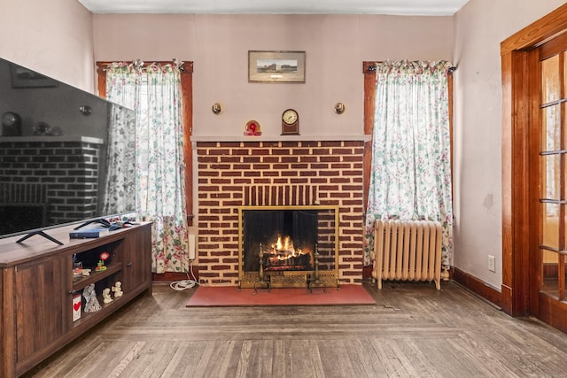 245 Ledyard St, New London, CT 06320 - living area with radiator and a fireplace