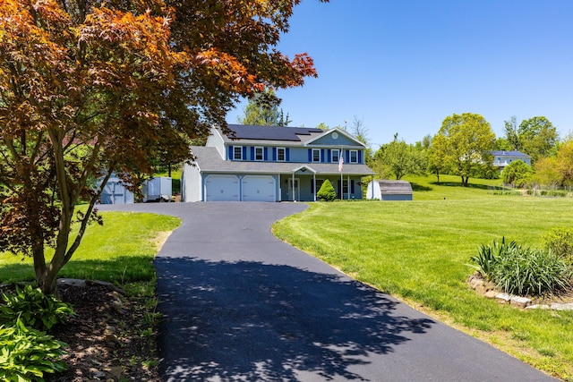 10 Spoonville Rd, East Granby, CT 06026 - traditional-style house with a front lawn, solar panels, asphalt driveway, and covered porch
