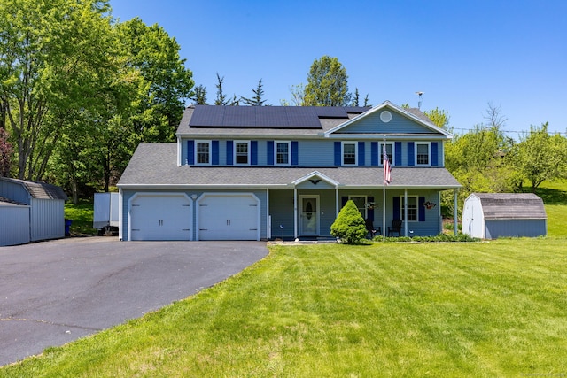10 Spoonville Rd, East Granby, CT 06026 - view of front of home featuring covered porch, roof mounted solar panels, a front lawn, asphalt driveway, and roof with shingles