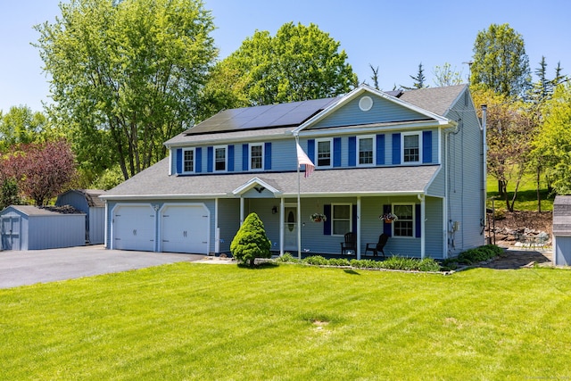 10 Spoonville Rd, East Granby, CT 06026 - view of front of home featuring covered porch, roof mounted solar panels, a front yard, asphalt driveway, and a shingled roof