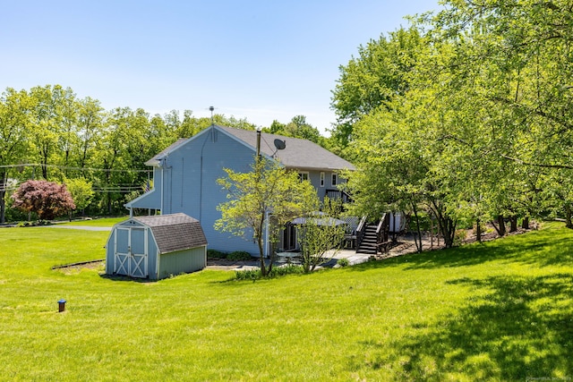 10 Spoonville Rd, East Granby, CT 06026 - rear view of house featuring stairway, a lawn, and a shingled roof