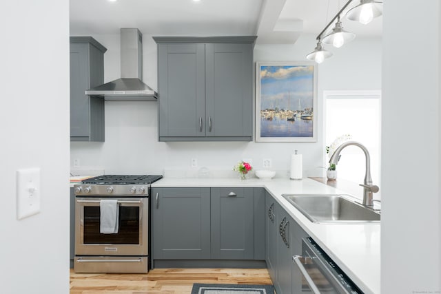 276 Niantic River Rd, Waterford, CT 06385 - kitchen with wall chimney range hood, stainless steel range with gas cooktop, gray cabinetry, and dishwasher