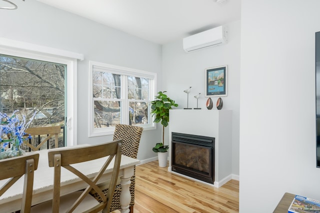 276 Niantic River Rd, Waterford, CT 06385 - home office with a wall mounted air conditioner, a glass covered fireplace, and light wood finished floors