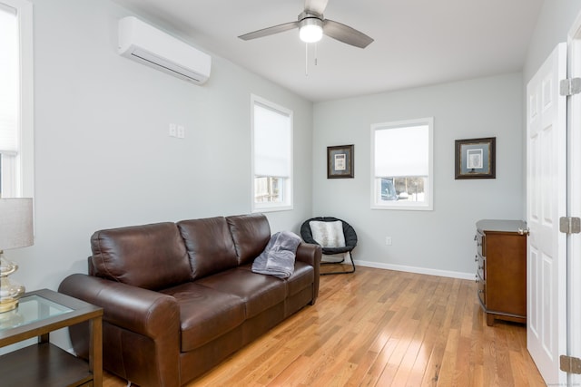 276 Niantic River Rd, Waterford, CT 06385 - living room with a wall mounted air conditioner, light wood-style flooring, and ceiling fan