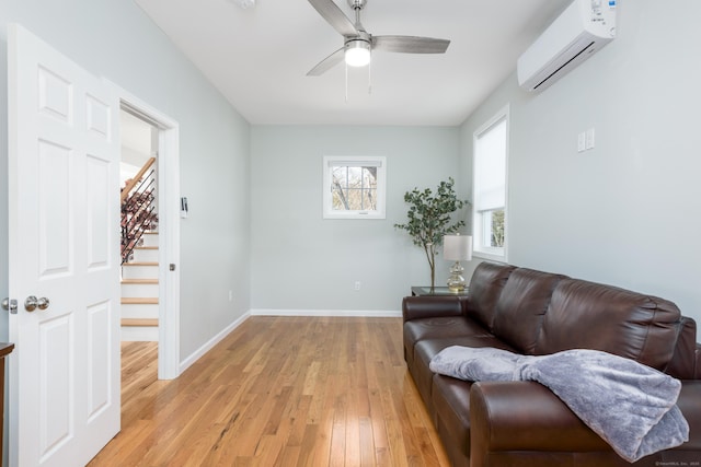 276 Niantic River Rd, Waterford, CT 06385 - sitting room featuring a wall mounted air conditioner, stairway, light wood-style floors, and a ceiling fan
