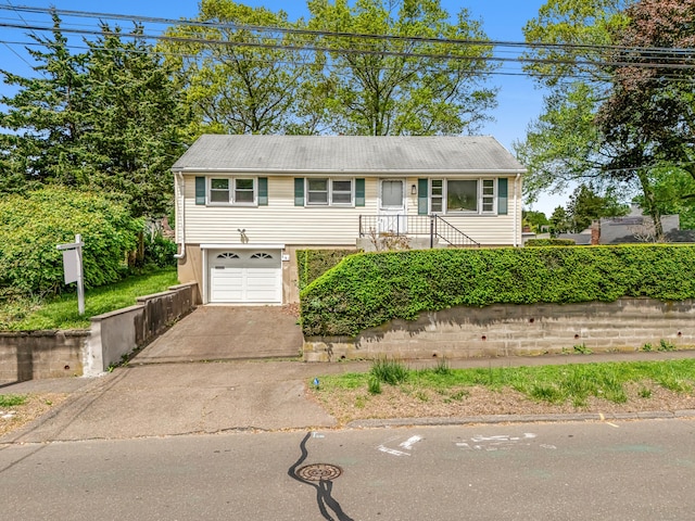 261 High St, Fairfield, CT 06824 - view of front of home featuring driveway and an attached garage