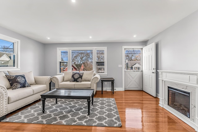 261 High St, Fairfield, CT 06824 - living area featuring wood finished floors, recessed lighting, a glass covered fireplace, and baseboards