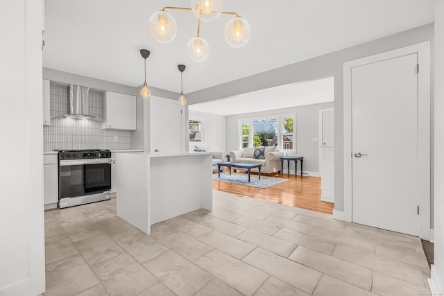 261 High St, Fairfield, CT 06824 - kitchen with stainless steel range oven, wall chimney exhaust hood, light countertops, decorative backsplash, and open floor plan