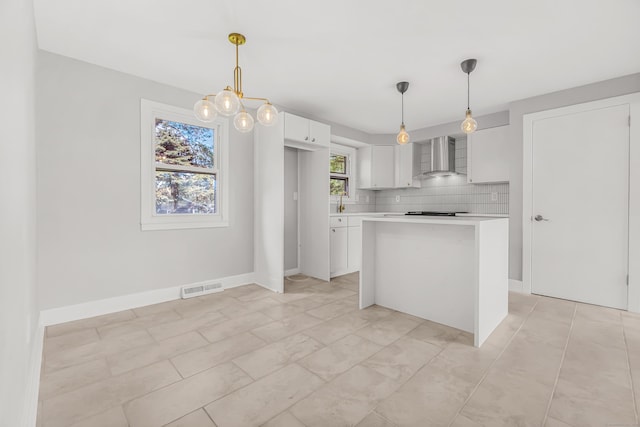 261 High St, Fairfield, CT 06824 - kitchen with wall chimney range hood, white cabinetry, light countertops, a center island, and tasteful backsplash