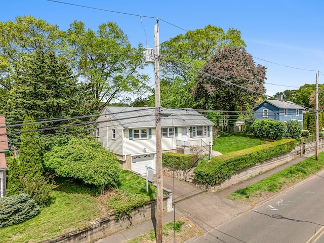 261 High St, Fairfield, CT 06824 - view of front of property featuring concrete driveway and an attached garage