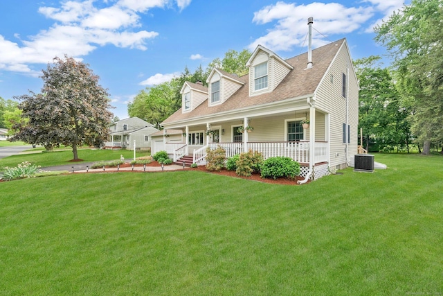 cape cod home featuring covered porch, a front lawn, cooling unit, roof with shingles, and a garage