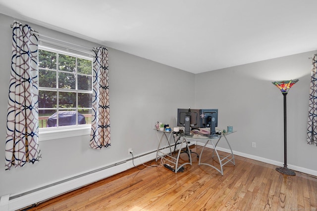 office with a baseboard radiator, wood finished floors, and baseboards