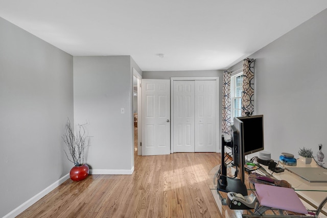 office with light wood-style floors and baseboards