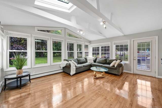 sunroom / solarium featuring a skylight, wood finished floors, and a wooden deck