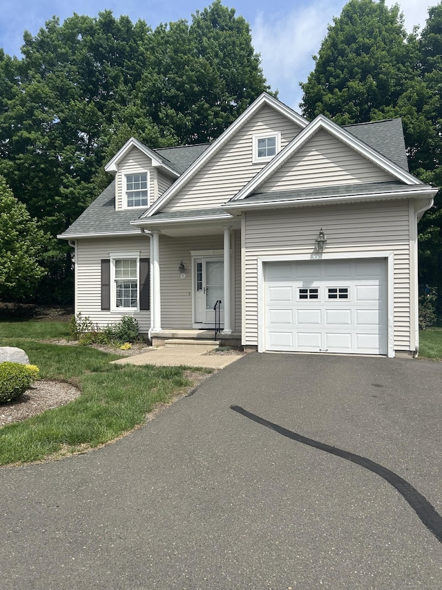 6 Aspen Way, Bristol, CT 06010 - view of front of house featuring a garage, asphalt driveway, and a shingled roof