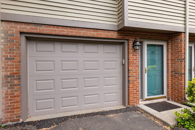 85 Metacomet Dr Unit 85, Meriden, CT 06450 - entrance to property featuring brick siding, driveway, and a garage