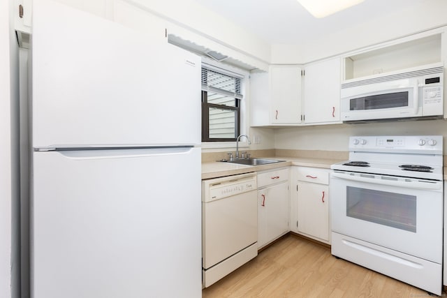 85 Metacomet Dr Unit 85, Meriden, CT 06450 - kitchen featuring white appliances, a sink, light wood-style floors, light countertops, and white cabinets