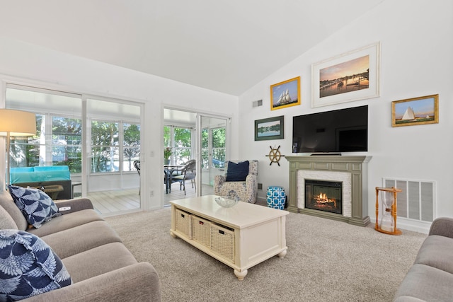 8 Cypress Way, Waterford, CT 06385 - living room with light colored carpet, vaulted ceiling, and a glass covered fireplace