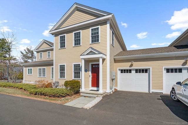 view of front of home featuring asphalt driveway and a garage