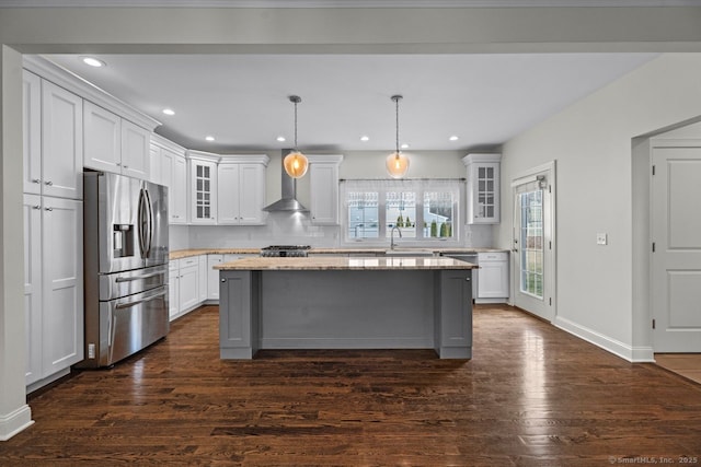 kitchen featuring stainless steel fridge, glass insert cabinets, dark wood-style floors, white cabinetry, and a kitchen island