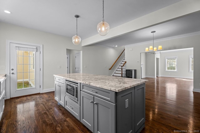 kitchen featuring gray cabinetry, stainless steel microwave, a chandelier, dark wood finished floors, and recessed lighting