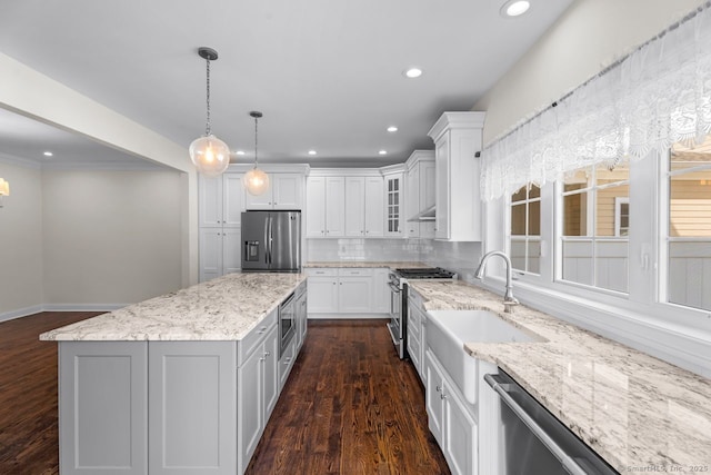 kitchen with appliances with stainless steel finishes, dark wood-style floors, recessed lighting, white cabinetry, and backsplash