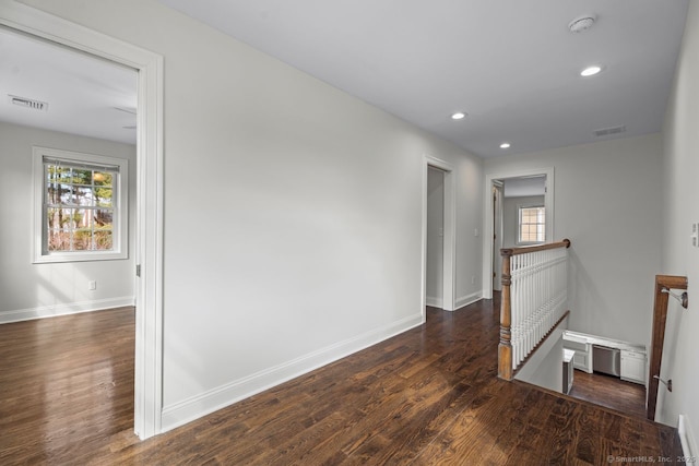 unfurnished room featuring plenty of natural light, wood finished floors, baseboards, recessed lighting, and a smoke detector