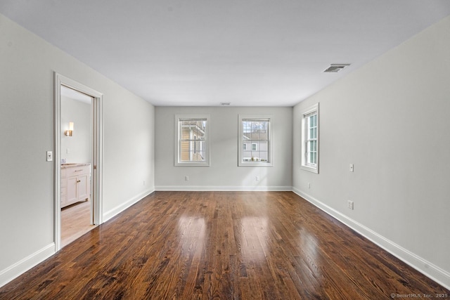 unfurnished room with dark wood finished floors and baseboards