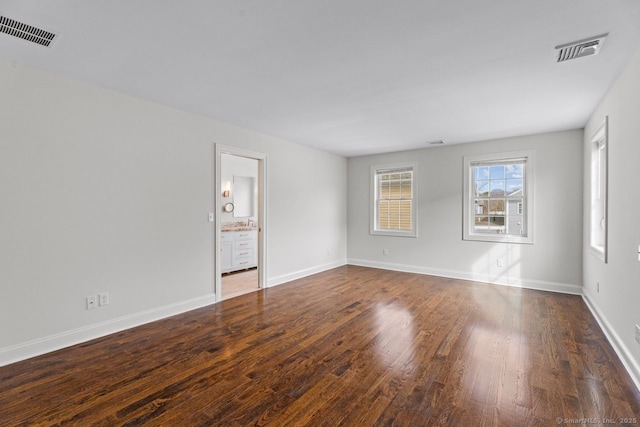 unfurnished room with wood finished floors and baseboards